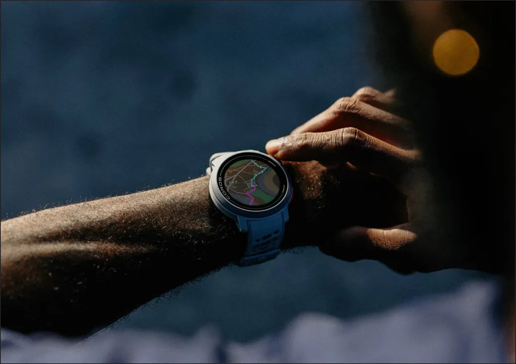Person using a smartwatch with a map displayed on the screen against a blurred background