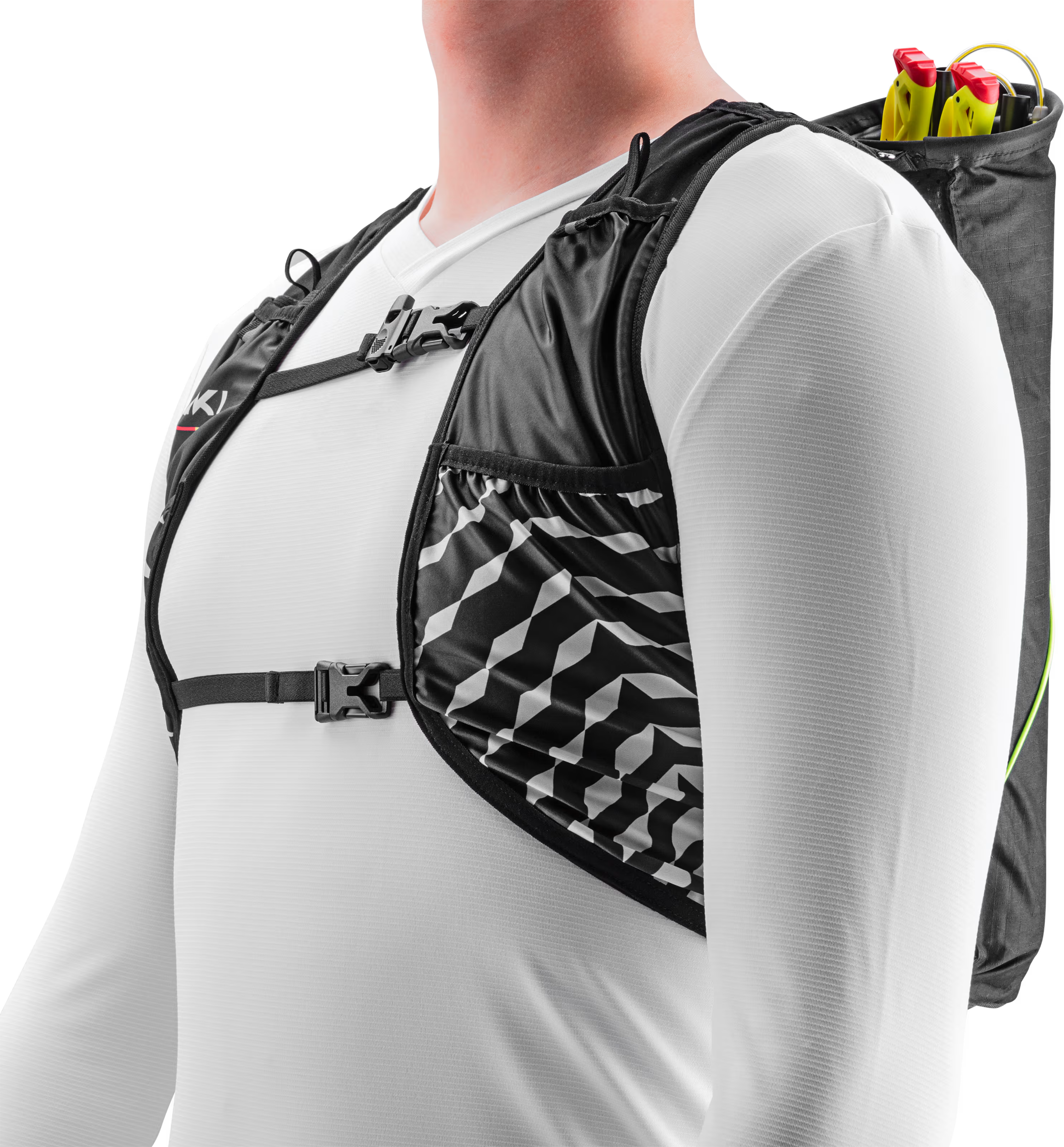 Person wearing a black and gray patterned hydration vest with a pole quiver, over a white shirt.
