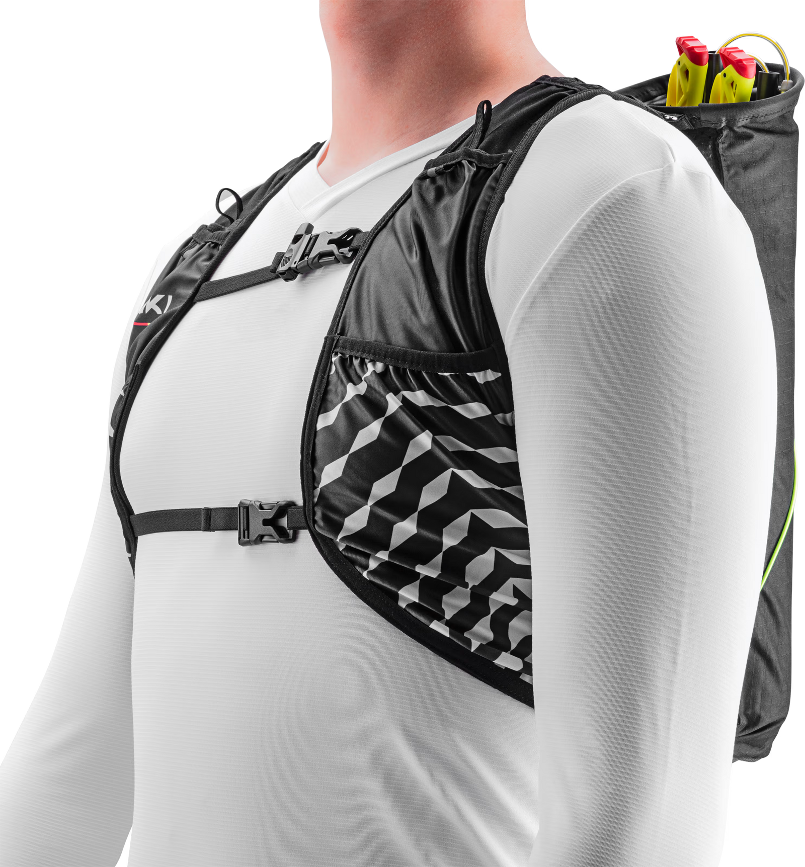Person wearing a black and gray patterned hydration vest with a pole quiver, over a white shirt.