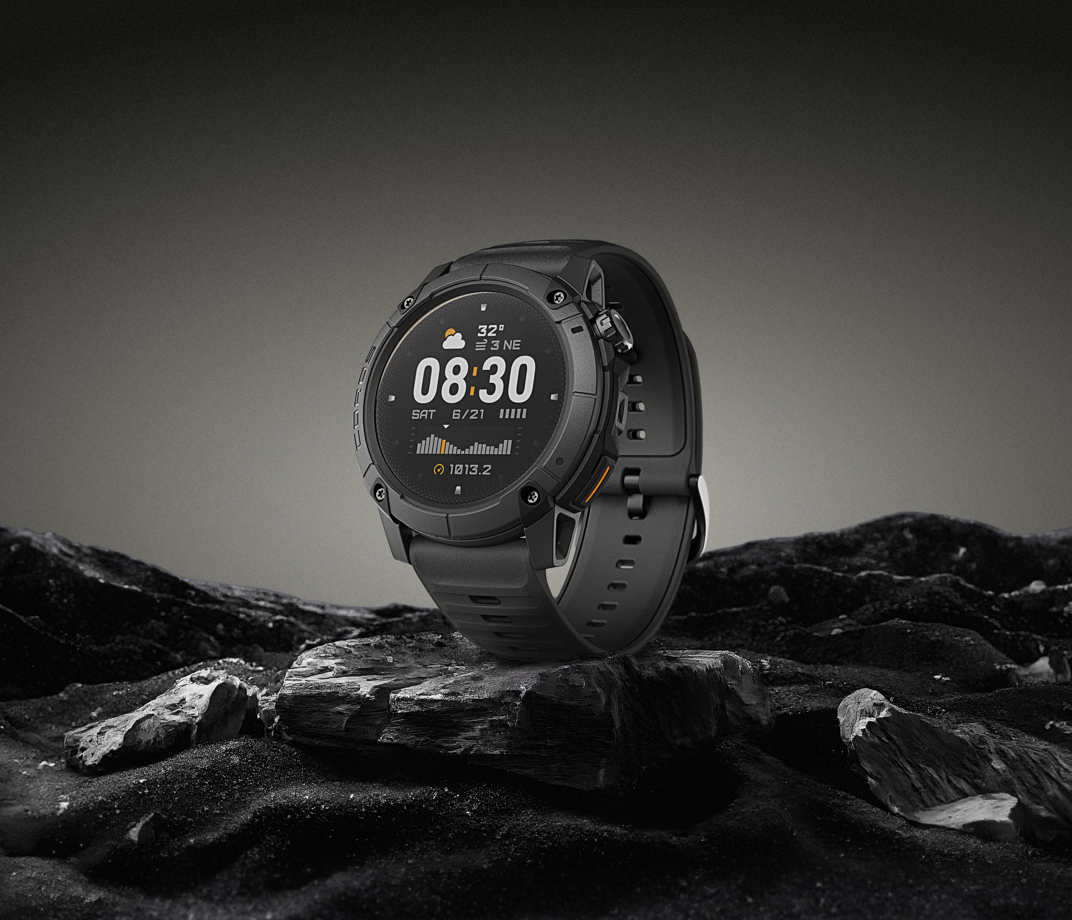 Black smartwatch on a rocky surface with a dark background