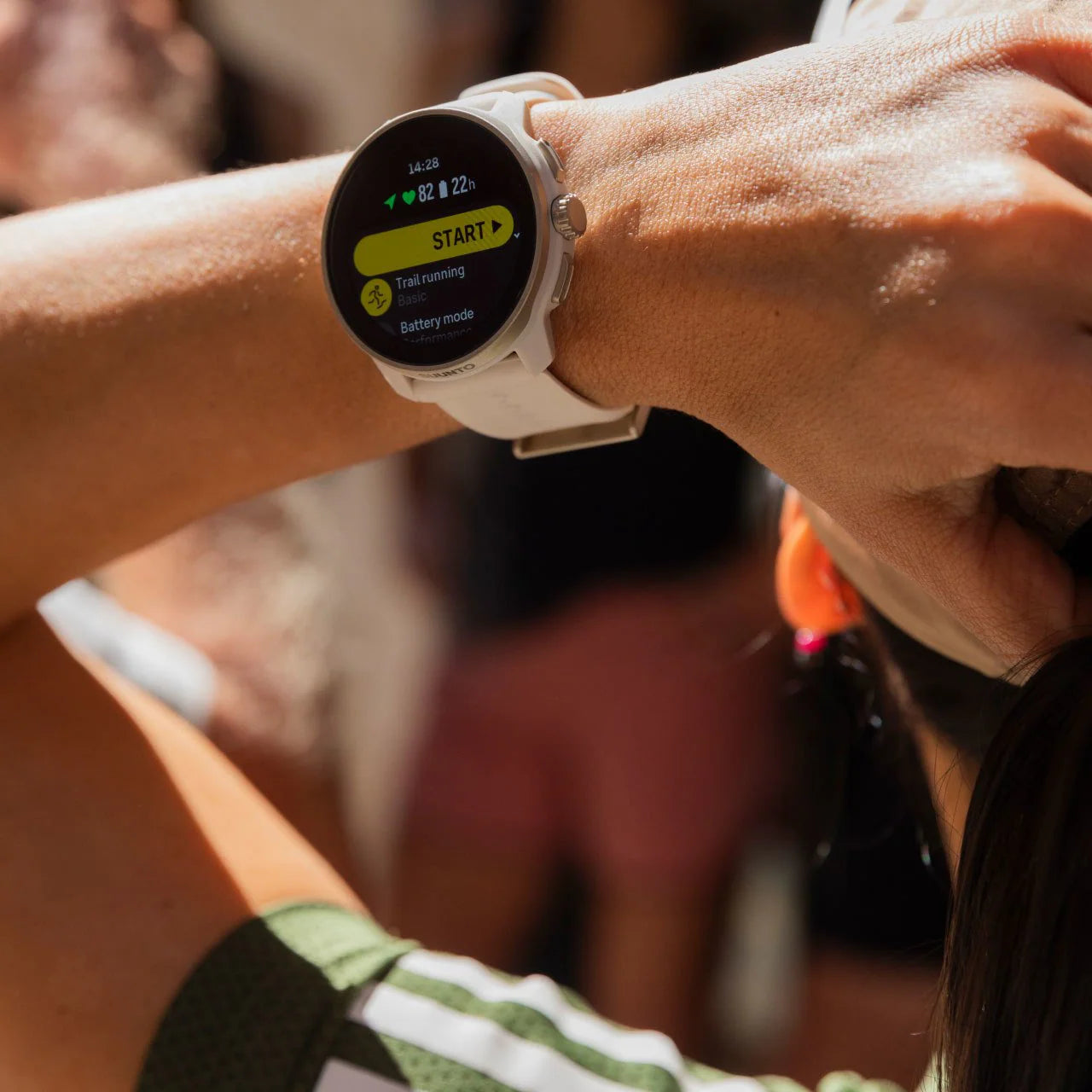 Person wearing a smartwatch with a blurred background