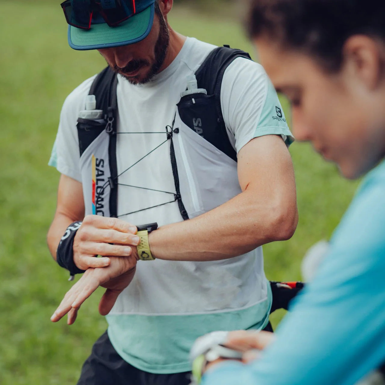 Person in athletic wear adjusting a watch outdoors