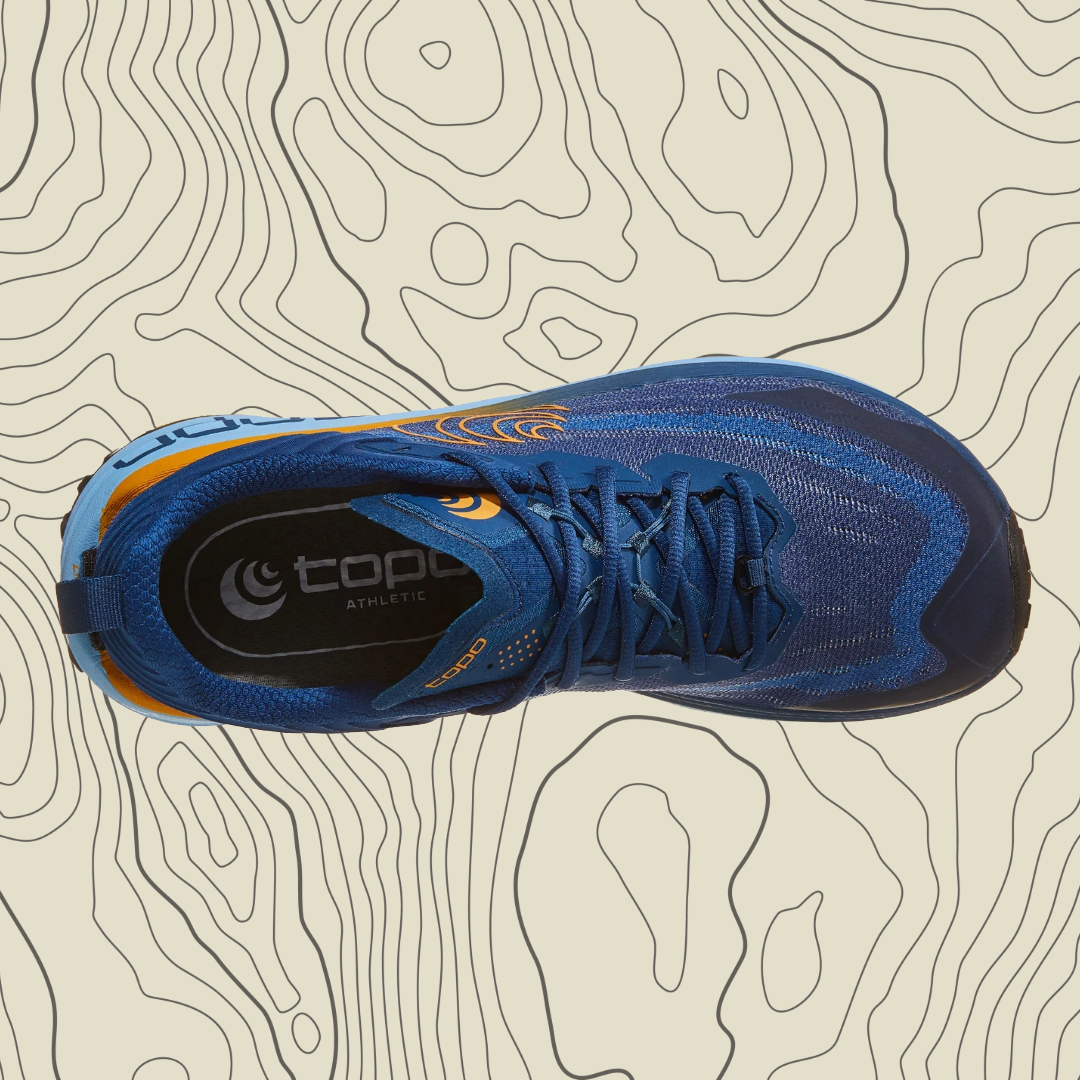 Blue athletic shoe with orange accents on a topographic background